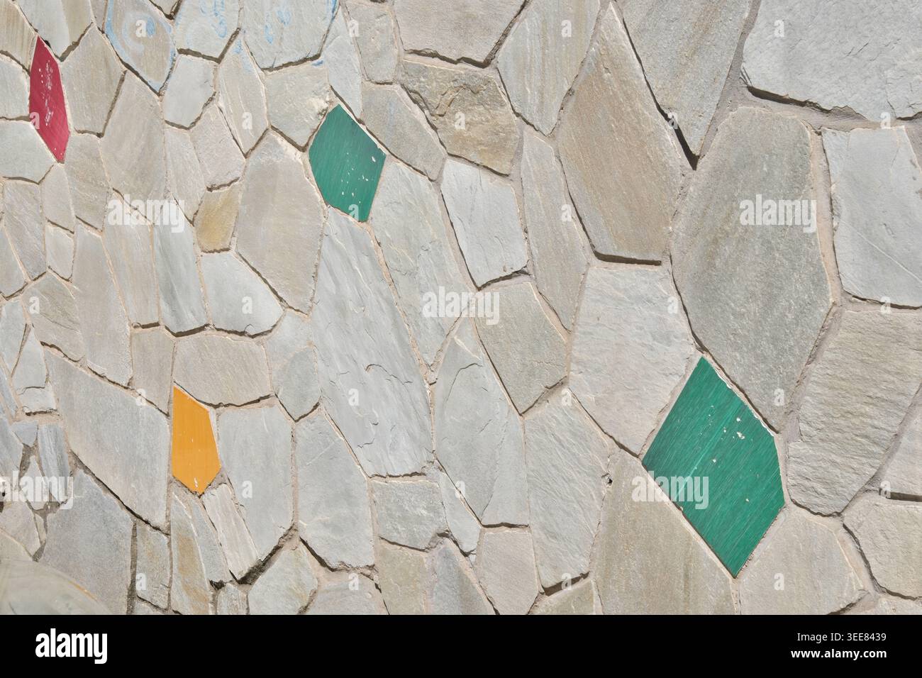 TEXTURE BACKGROUND OF A WALL WITH SOME COLORED BRICKS Stock Photo