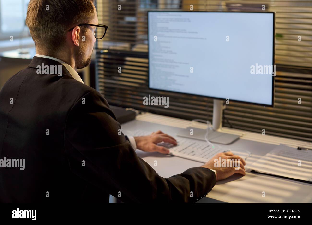 Business developer coding software on monitor in bright office workspace Stock Photo