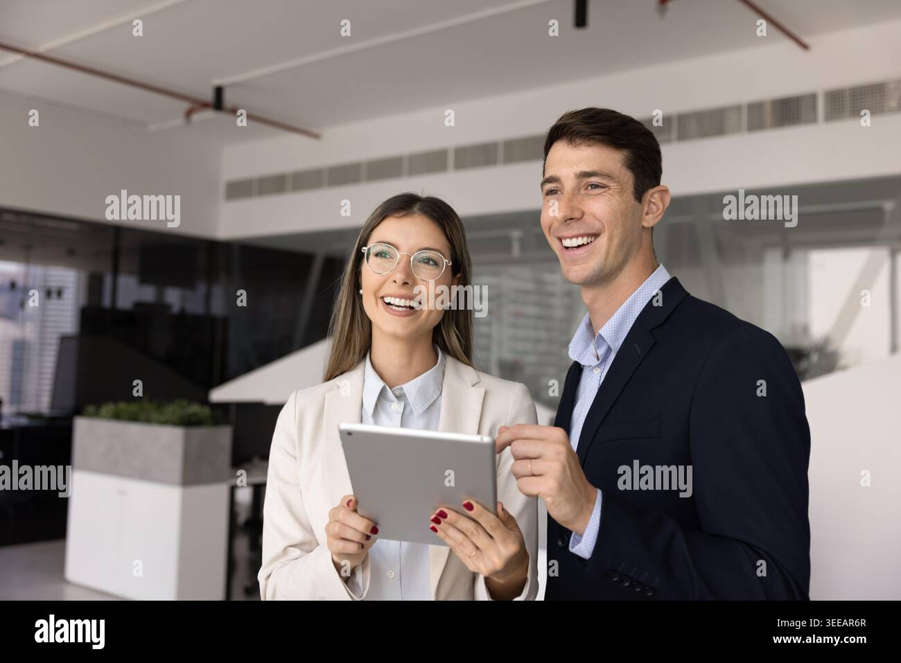 Young business team collaborating on project using digital tablet Stock Photo
