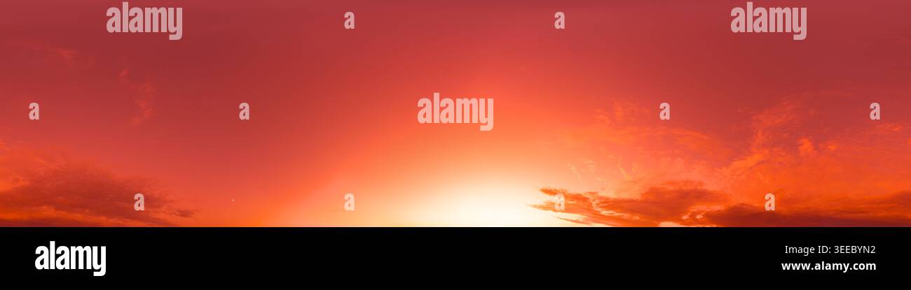 Sunset sky panorama shows vibrant orange and red colors with clouds at dawn for background and copy space Stock Photo