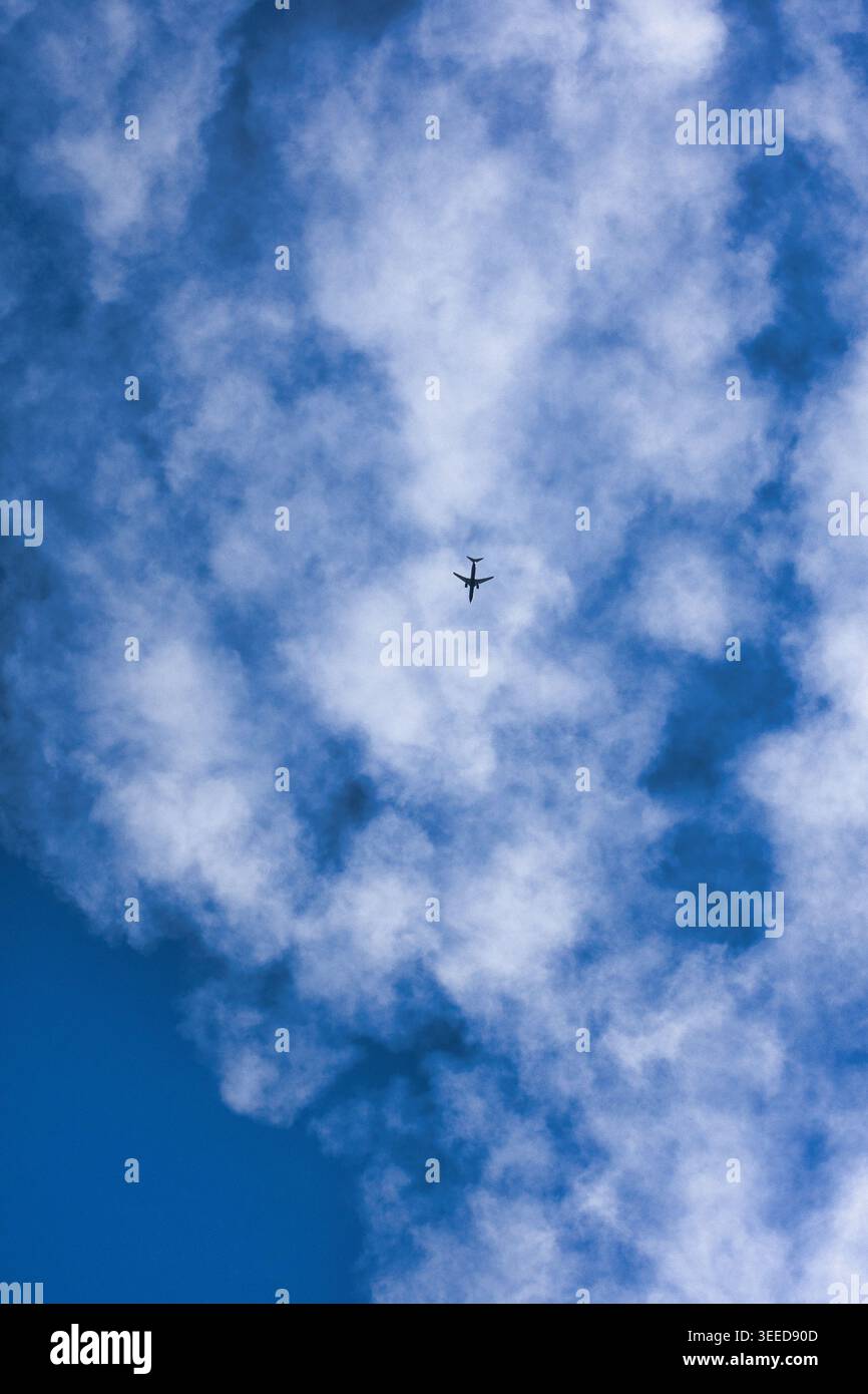 Airplane flying through soft clouds, with a dramatic sky and a sense of ...