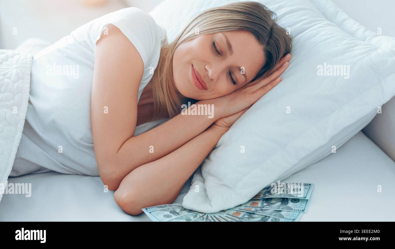 Woman Sleeping Peacefully With Cash on Bed in a Bright Room Stock Photo