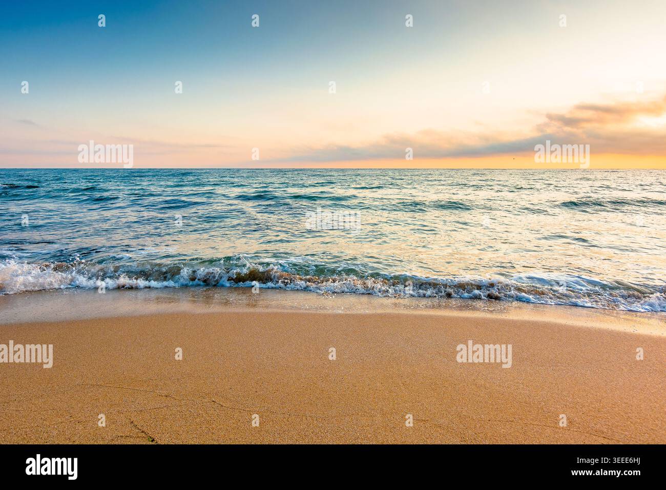 autumn vacation at the sea. beautiful seascape at sunrise. calm waves wash the sandy beach. image with fluffy clouds on the sky above horizon. perfect Stock Photo