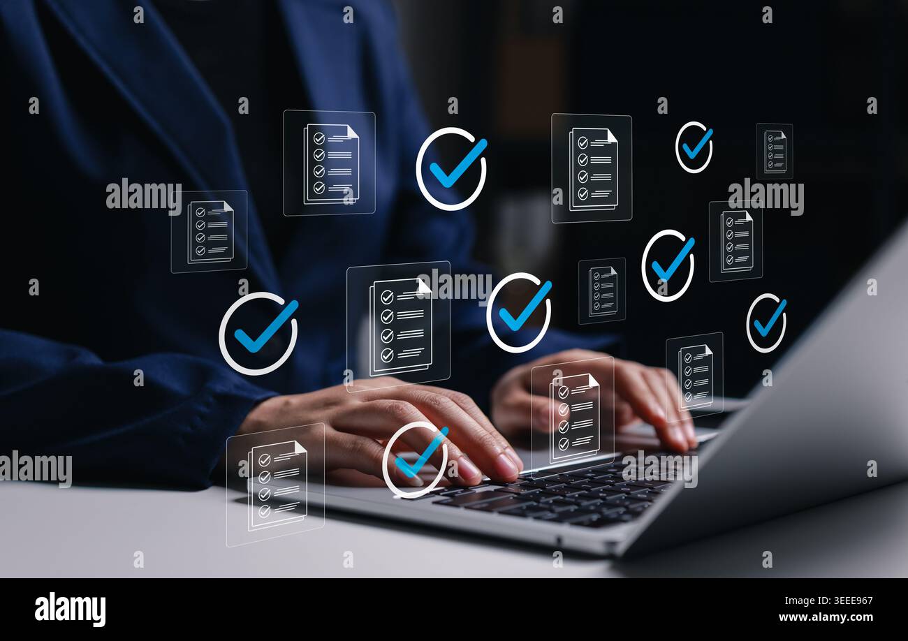 Document checklist approval and workflow verification concept. Professional using laptop with approved files, check marks, task validation, compliance Stock Photo