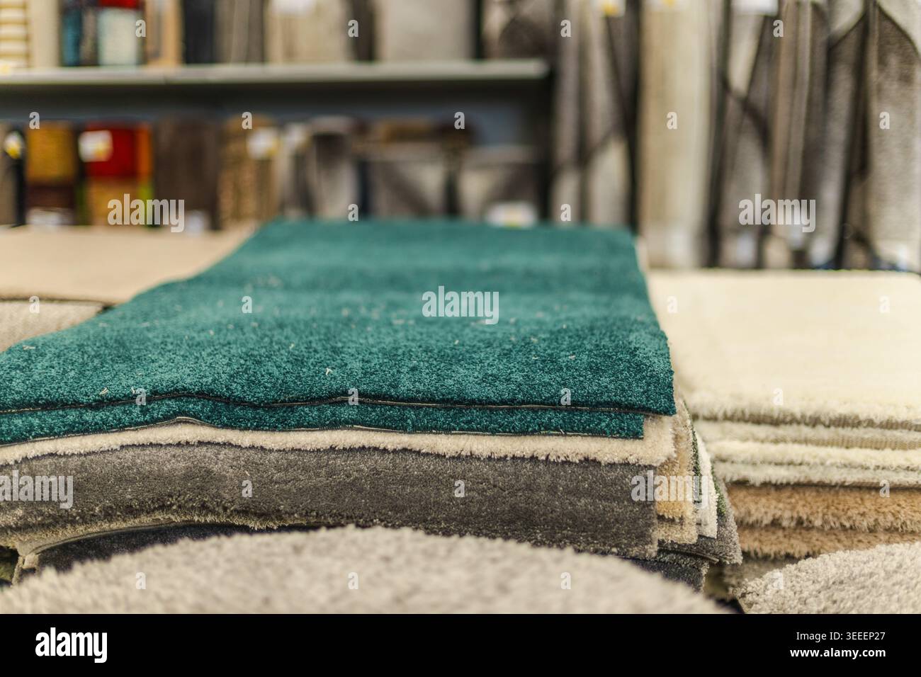 Stacked carpet samples and textile flooring materials in home improvement store Stock Photo