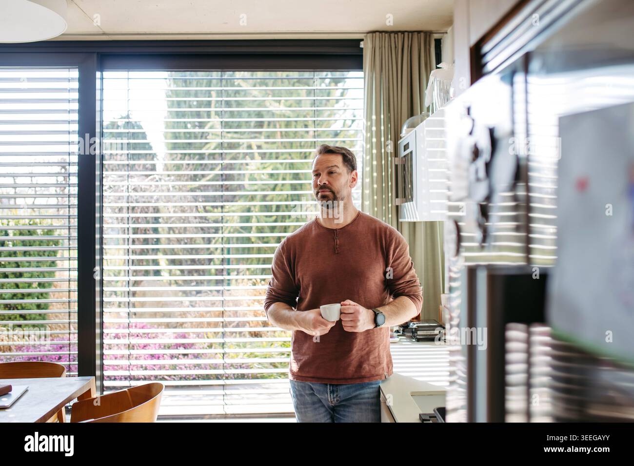 Man preparing coffee in modern kitchen at home. Stock Photo