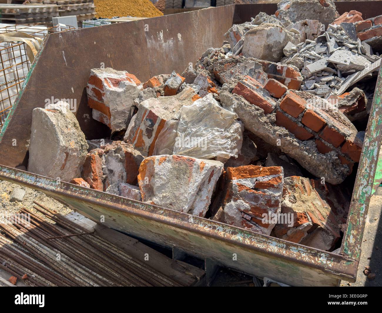 Container with construction rubble from demolition work (old bricks) Stock Photo