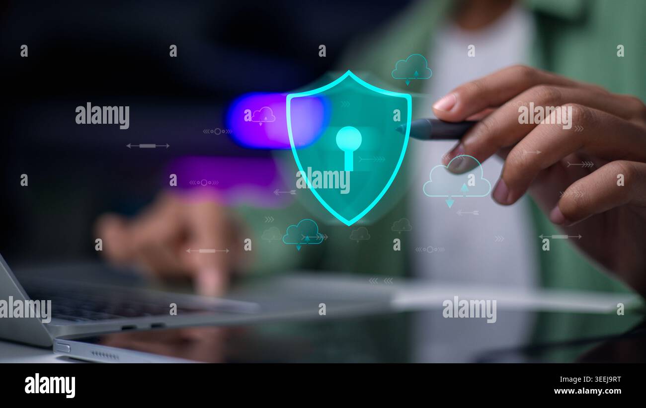 Hand using laptop with virtual shield and cloud icons. Cyber security, data storage protection, cloud computing safety, and network encryption technol Stock Photo