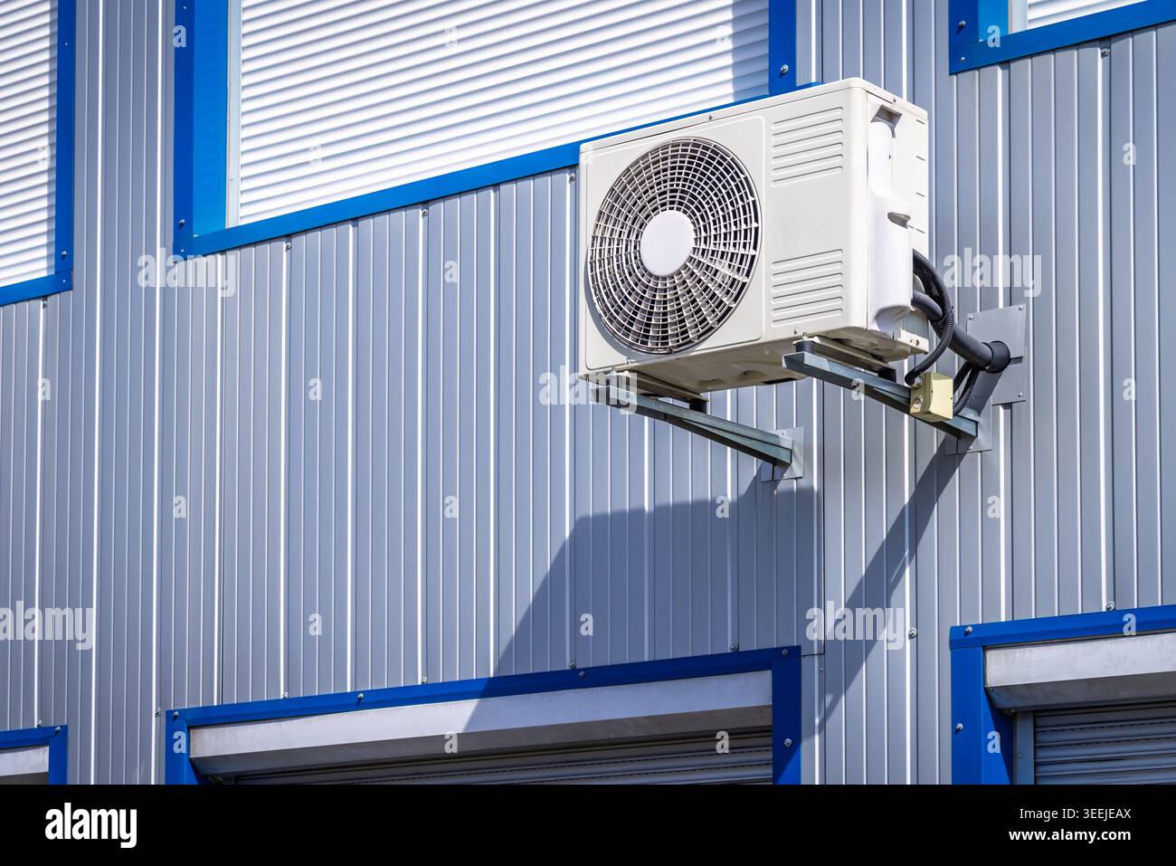 Split pump installed on a wall of industrial building, heating and cooling system Stock Photo