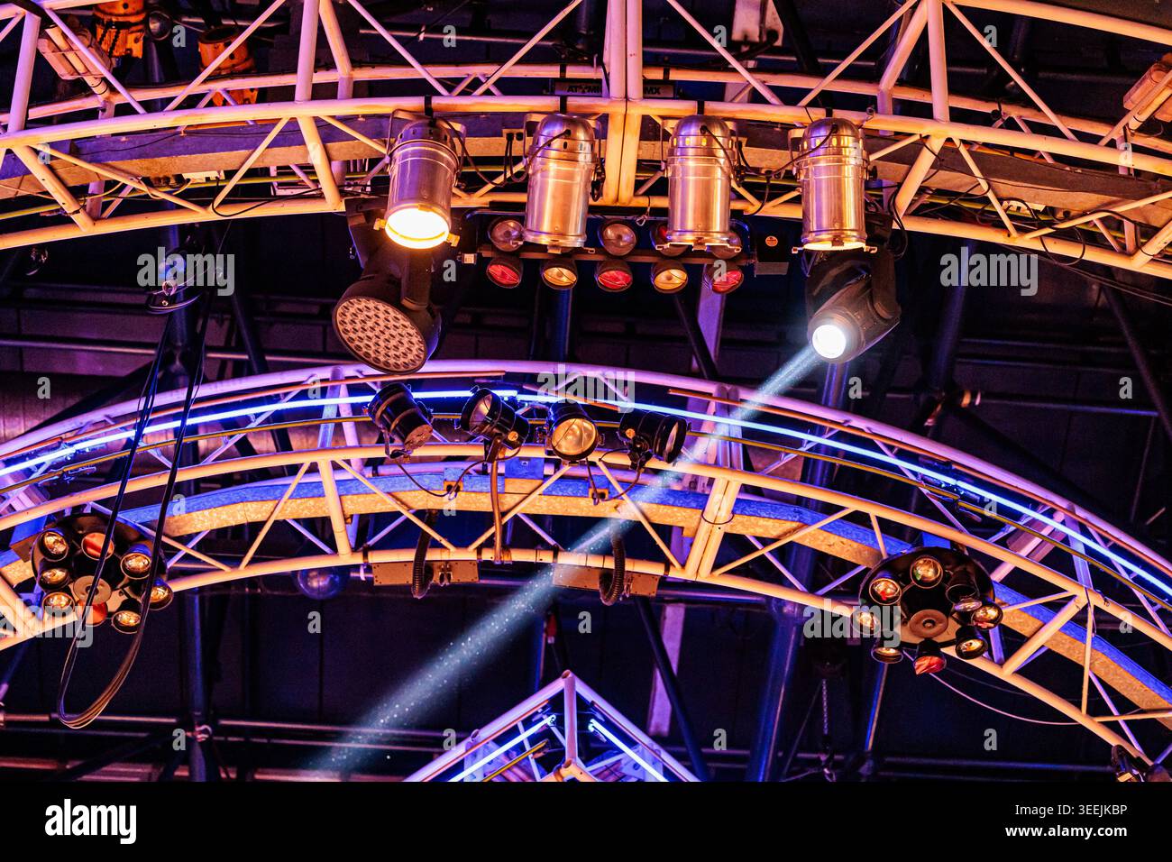 Colorful stage lighting rig with spotlights, moving heads and metal ...