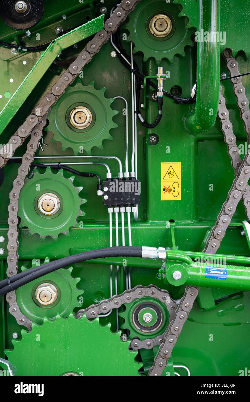 Internal workings of a big baler, showing cogs and chains. North Yorkshire, UK. Stock Photo