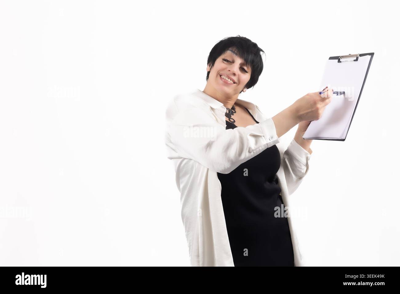 Female doctor or office worker holding clipboard and writing Stock Photo