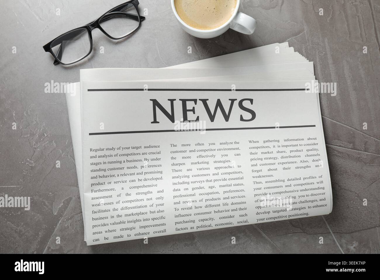 Newspaper, coffee and glasses on grey table, flat lay Stock Photo