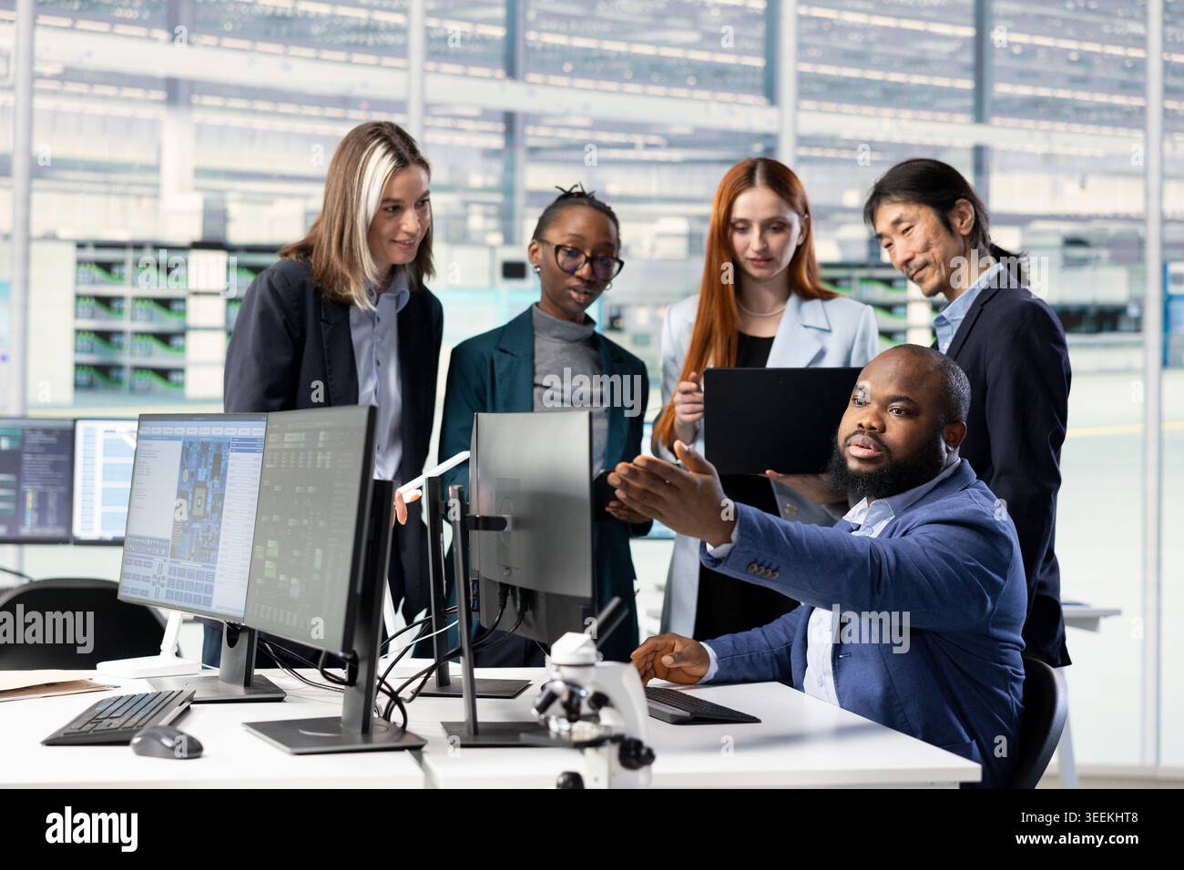 Optimizing PCB production, collaboration and multiethnic engineering team in factory research office. Developing semiconductors powering electronics, teamwork and colleagues using computer software Stock Photo