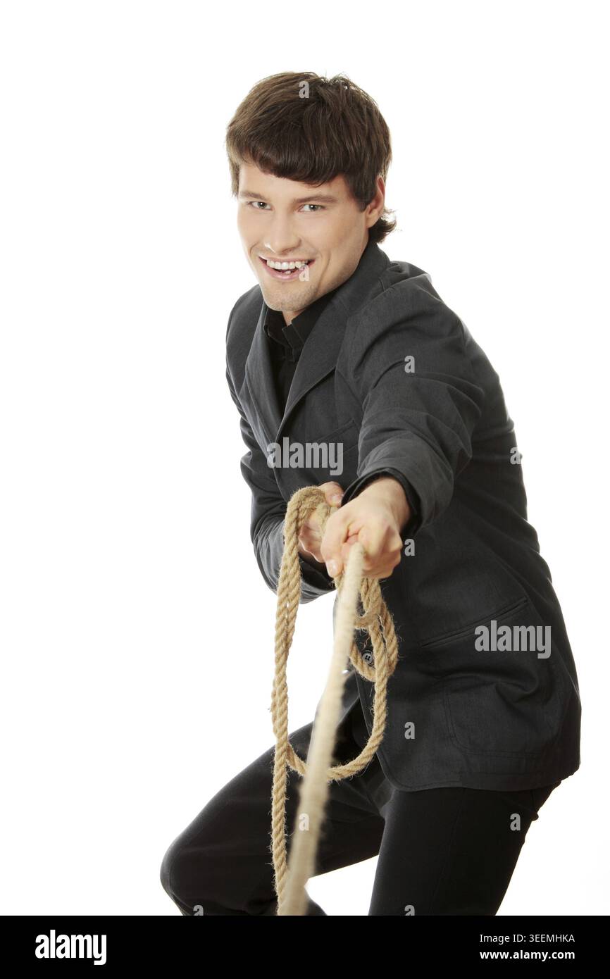 Businessman pulling on a rope. Isolated on white Stock Photo
