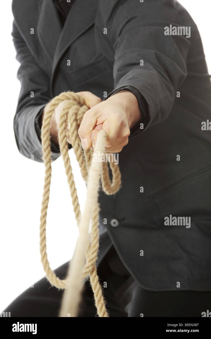 Businessman pulling on a rope. Isolated on white Stock Photo