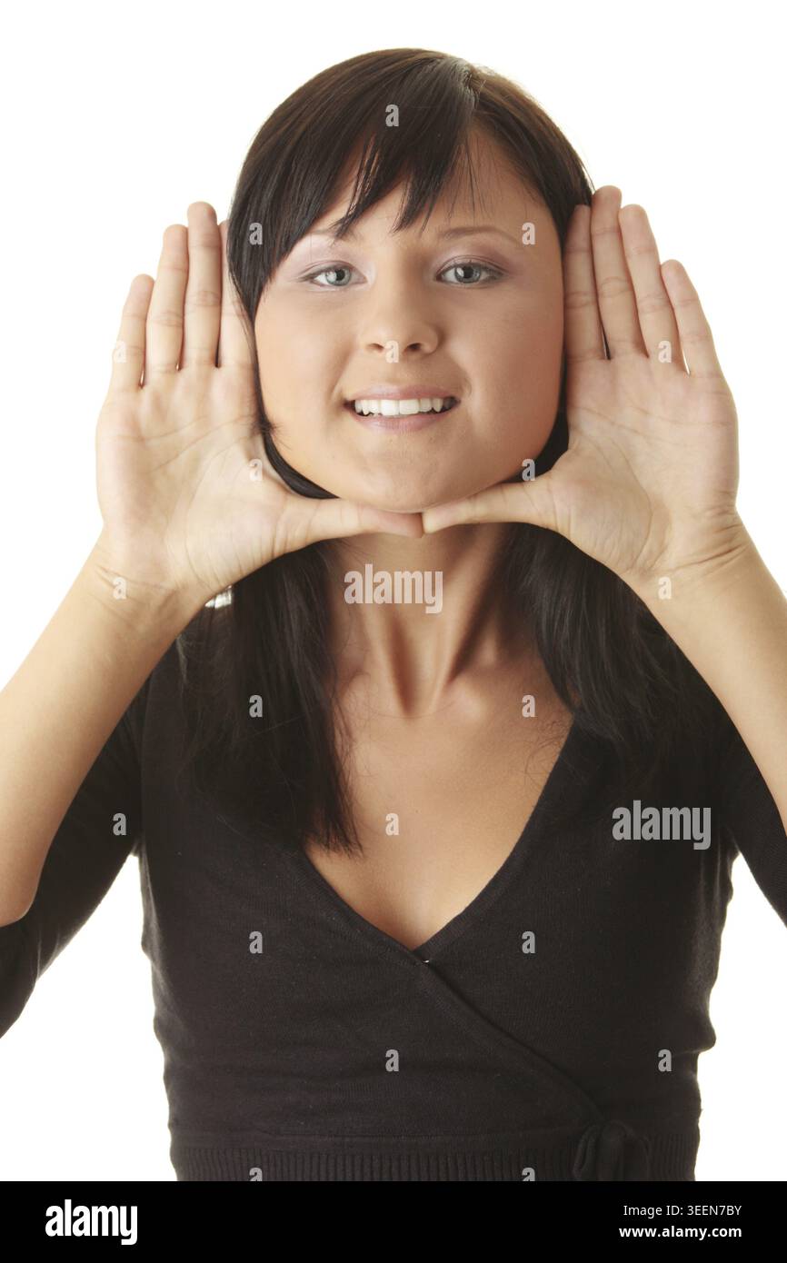 Young woman, framing her face with her hands Stock Photo