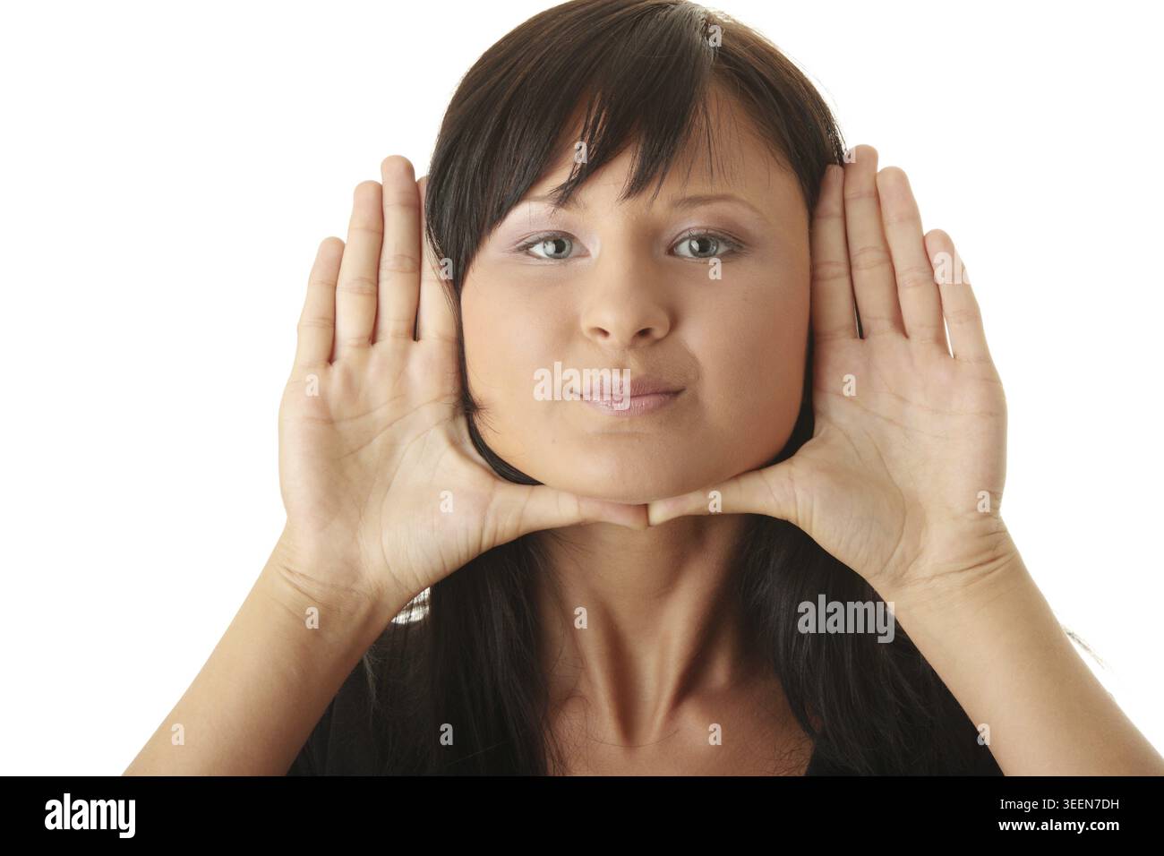 Young woman, framing her face with her hands Stock Photo
