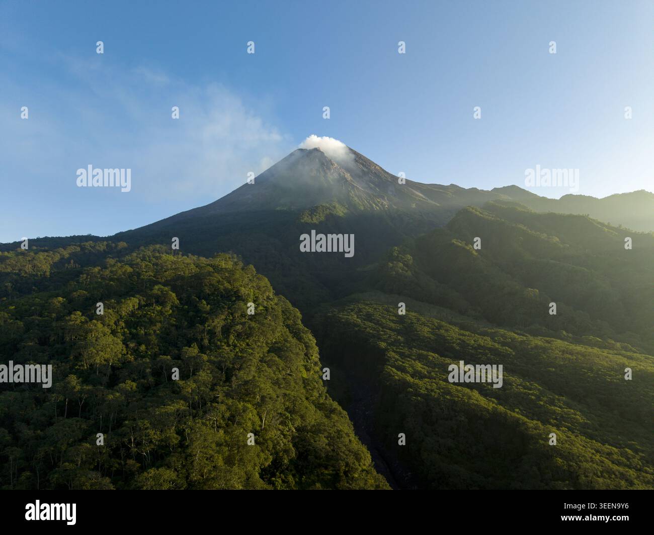 Aerial view of Mount Merapi volcano with smoke rising from the crater ...