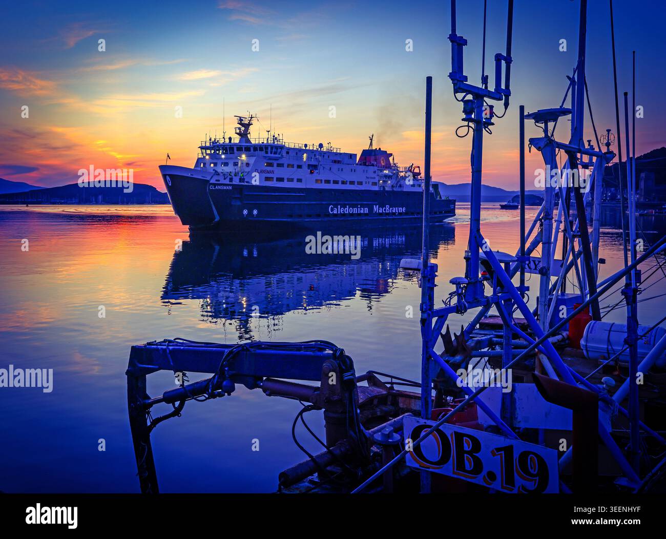 CalMac MV Clansman in Oban harbour at dusk, illustrating ferry disruption and lifeline service reliability for Scottish islands Stock Photo