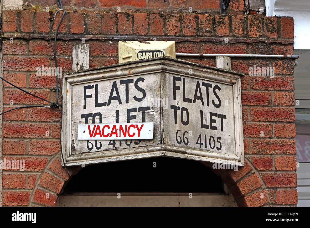 Weathered Flats to Let vacancy sign on a brick building, suggesting private rented sector pressures and poor quality homes Stock Photo