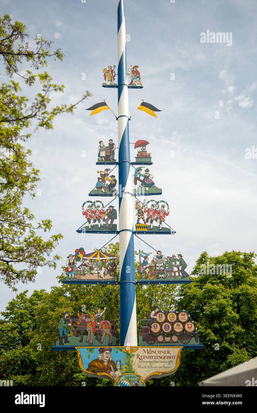 Viktualienmarkt maypole stands against the sky, illustrating bavarian ...