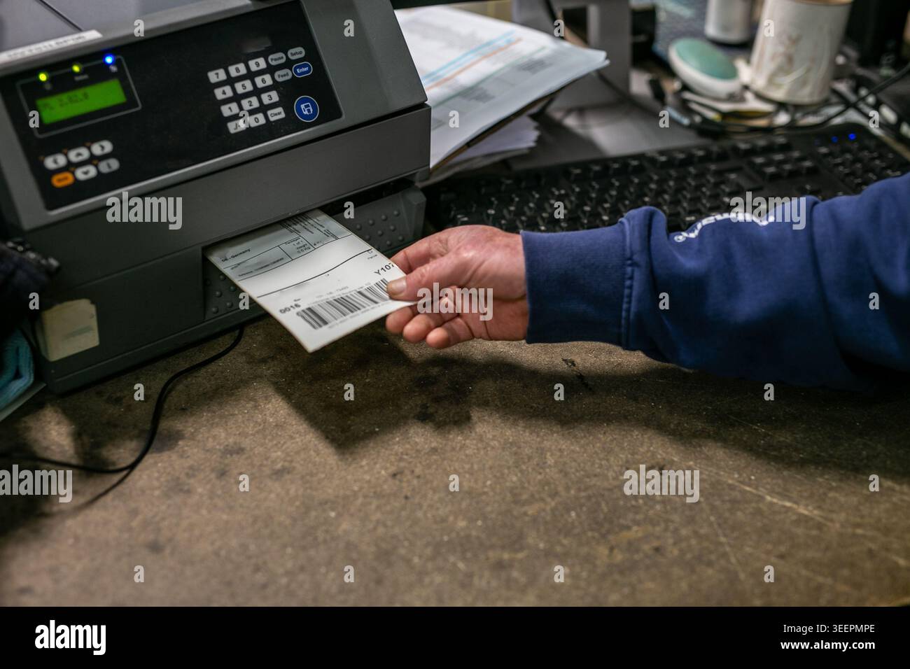 Bench Label Warehouse operative taking printed shipping labels from warehouse label ...
