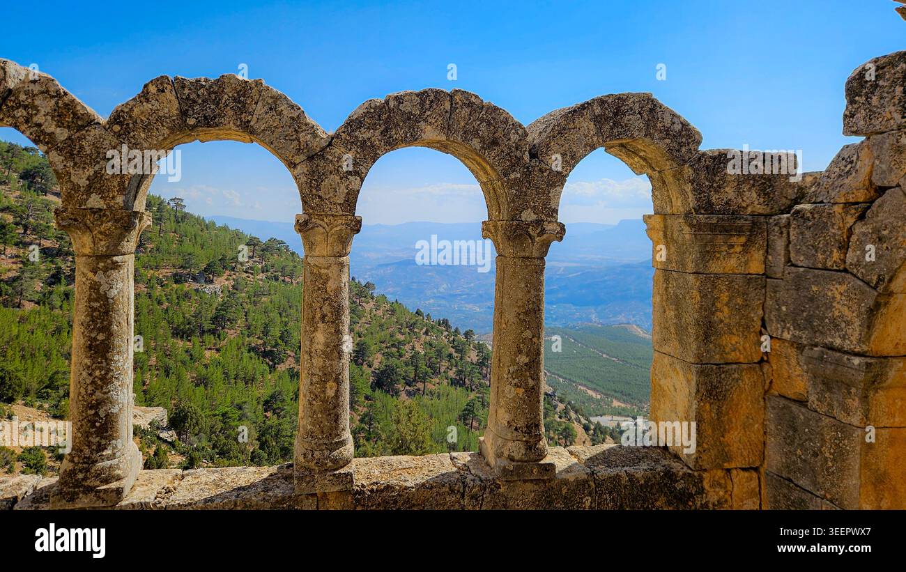 Series of ancient stone arches framing a distant mountain landscape ...