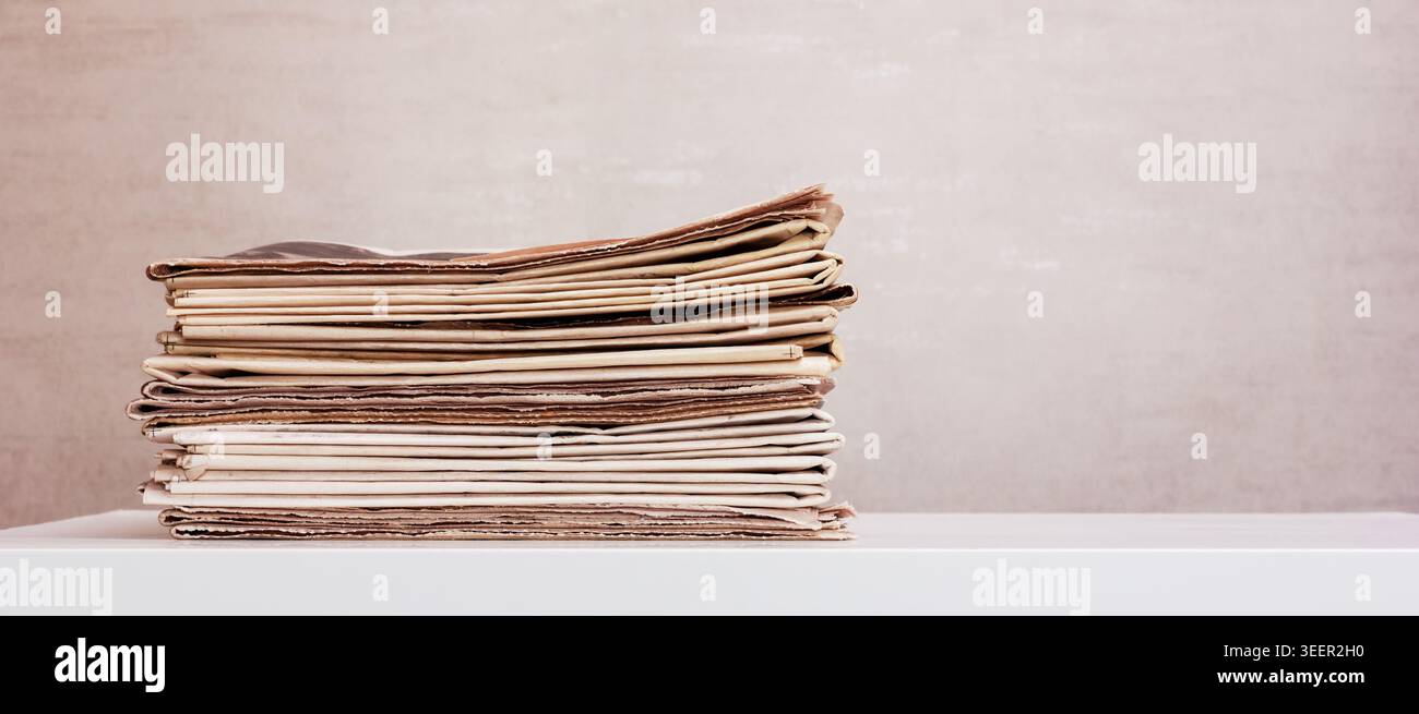 a large stack of newspapers on the table with copy space Stock Photo