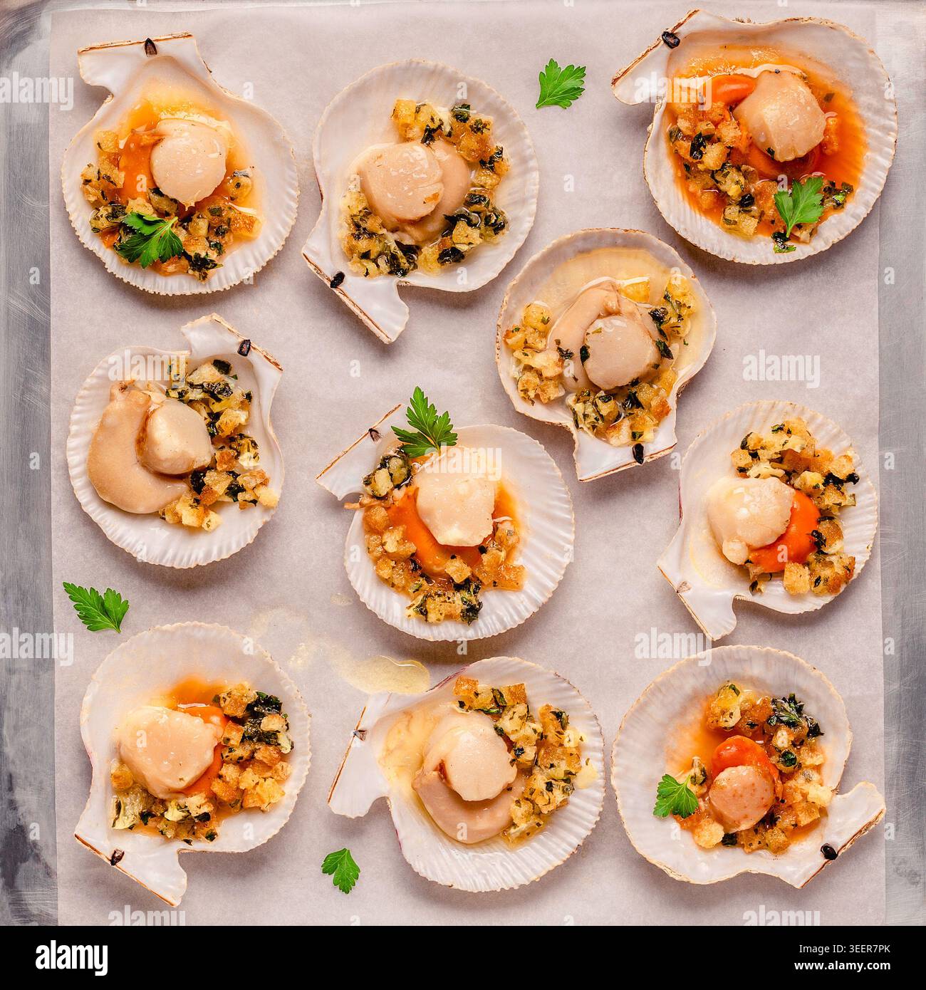 Cooked scallops with sauce on a baking sheet Stock Photo