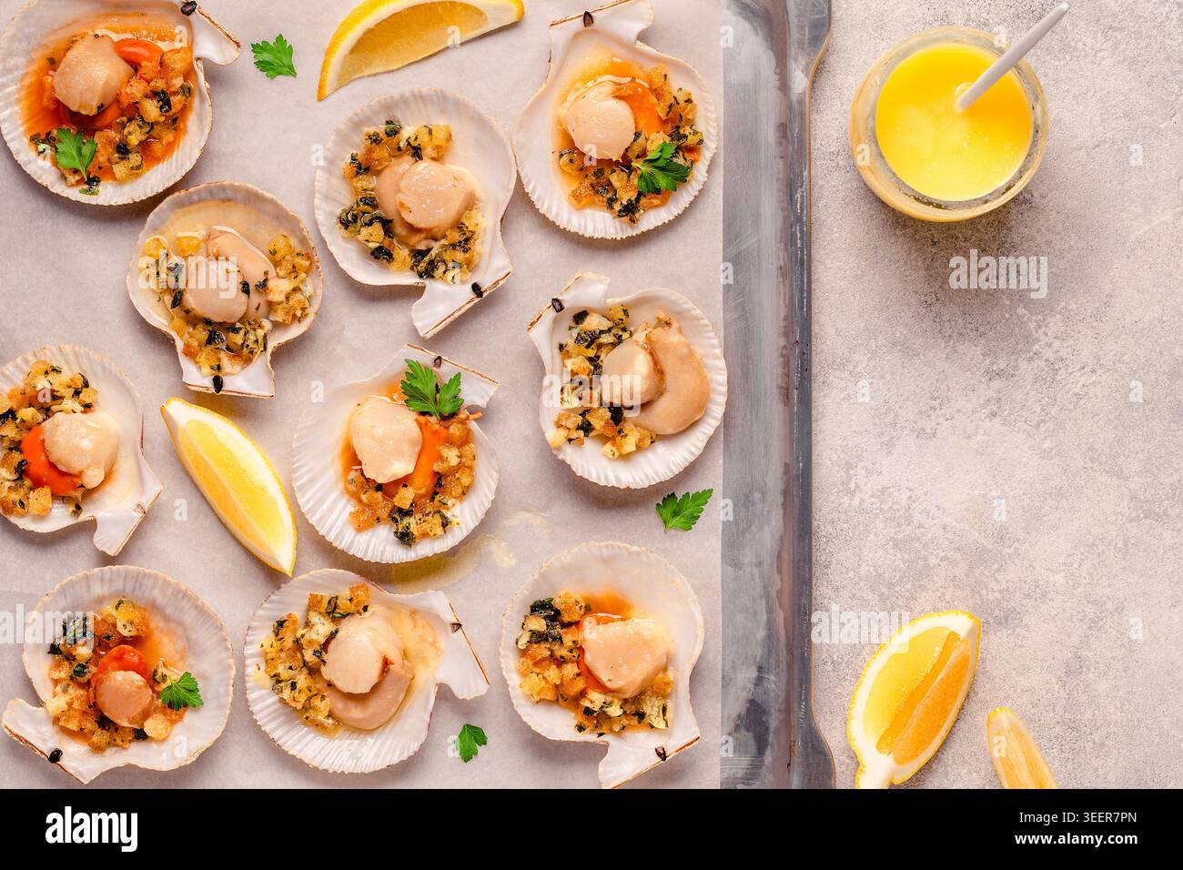 Cooked scallops with sauce on a baking sheet Stock Photo