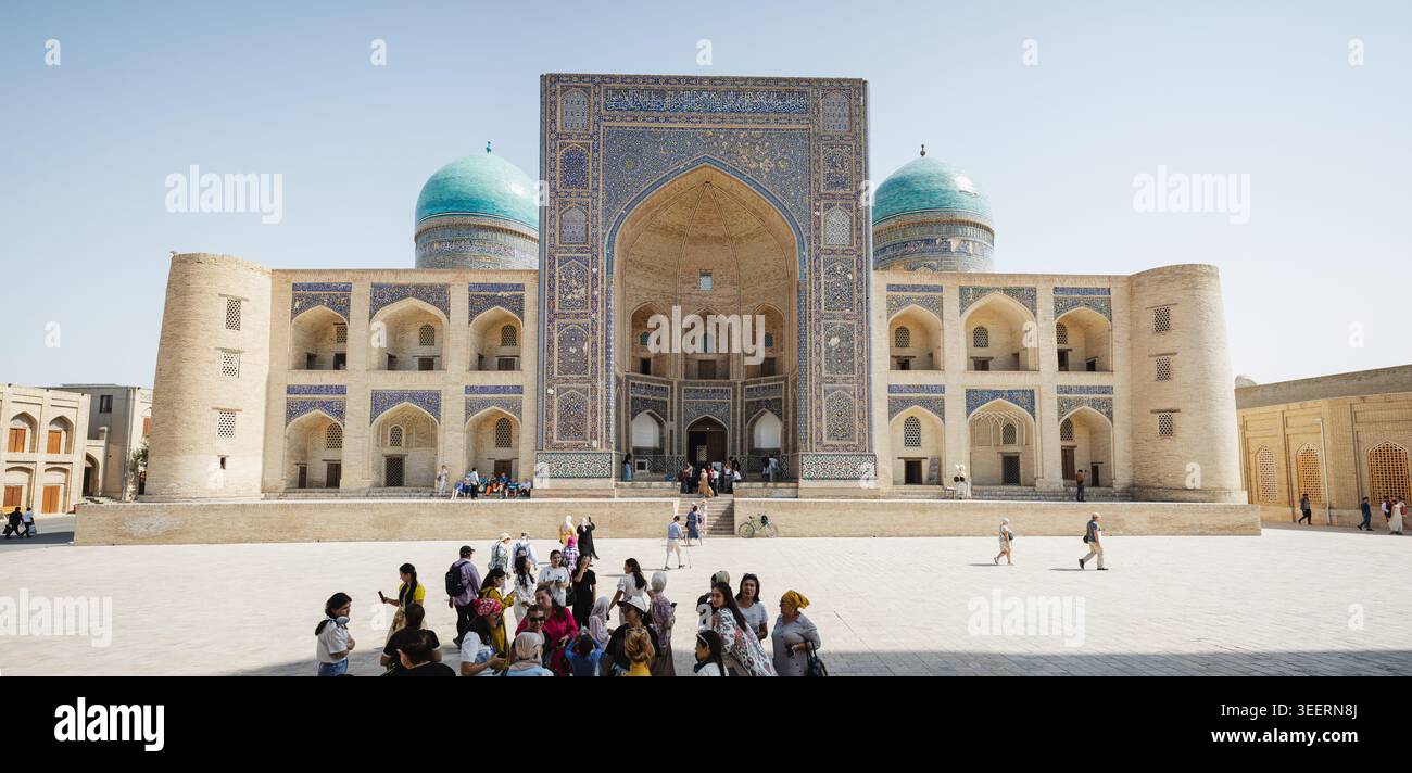 A wide horizontal view of the grand 16th-century Mir-i-Arab Madrasah in Bukhara, Uzbekistan. The image captures its magnificent central mosaic iwan po Stock Photo