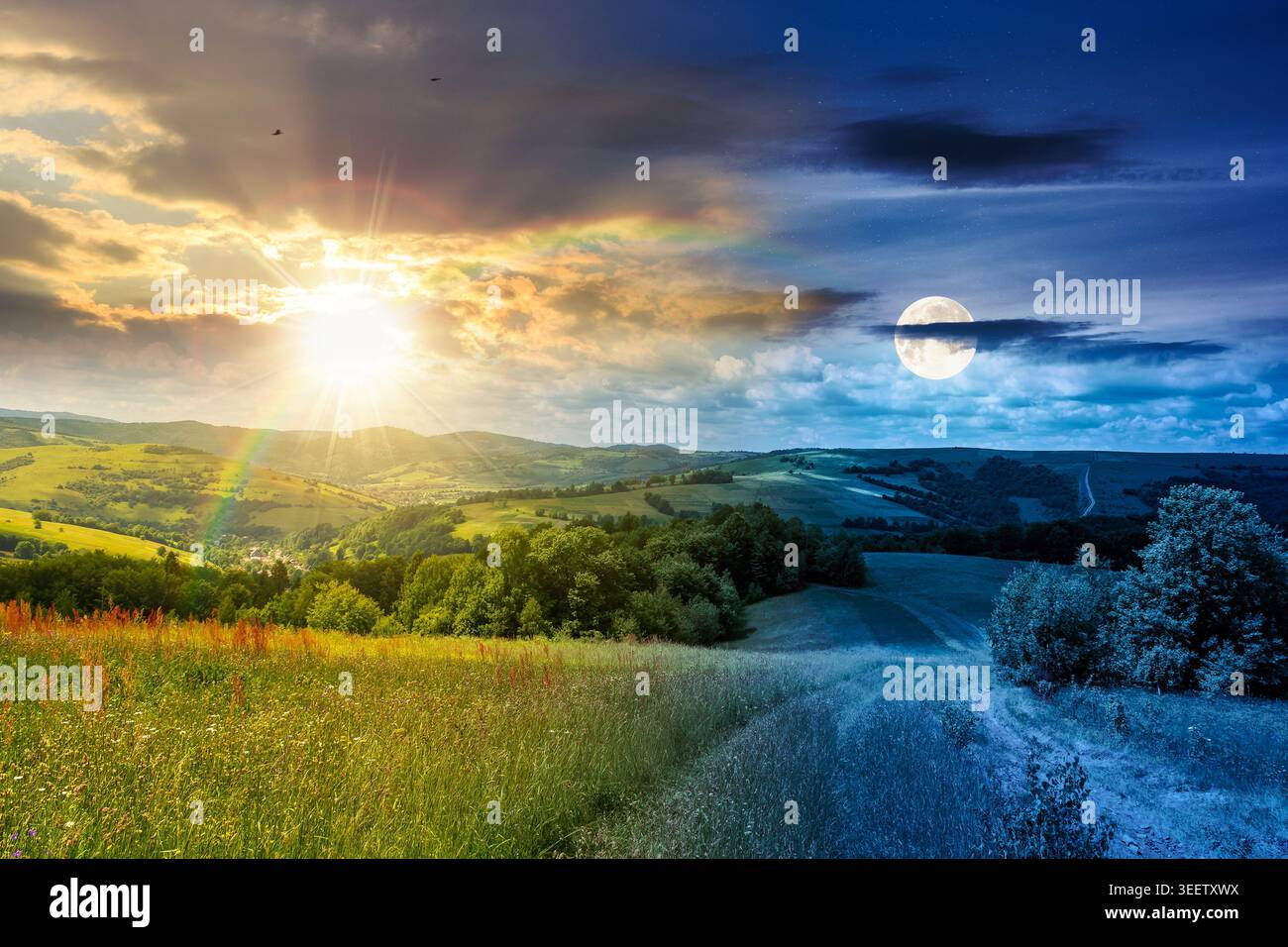 day meet night in beautiful countryside. epic view landscape in mountains on summer solstice. sun and moon in harmony over trail through the grassy fi Stock Photo