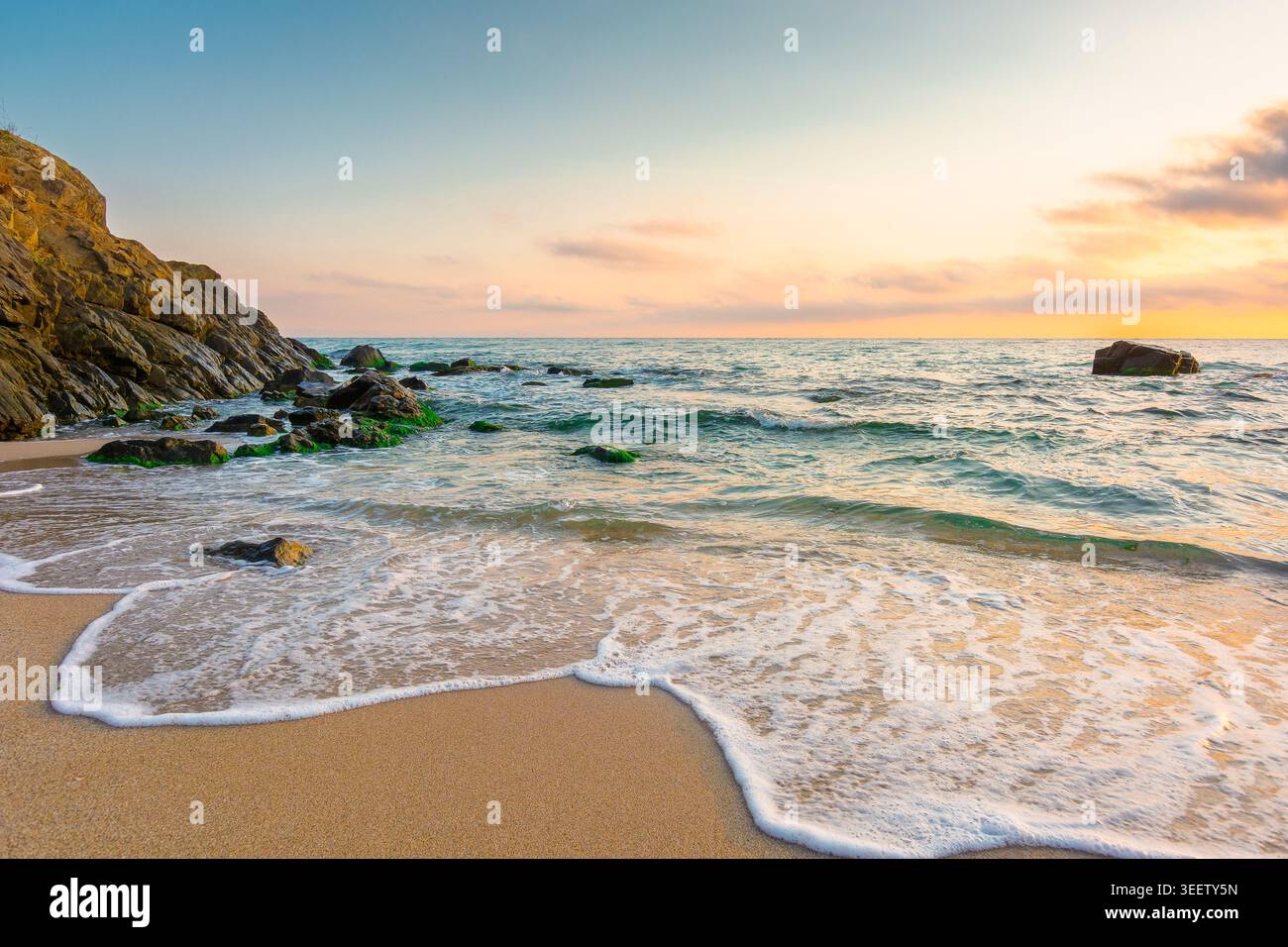 sandy beach of a black sea at sunrise. bulgaria scene on hot summer vacation season. beautiful view of waves washing the sand in morning light. generi Stock Photo