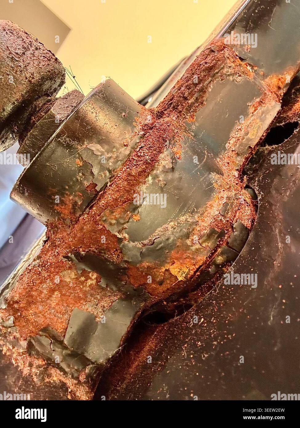futon hinge rust corrosion bent metal parts close-up damage inspection