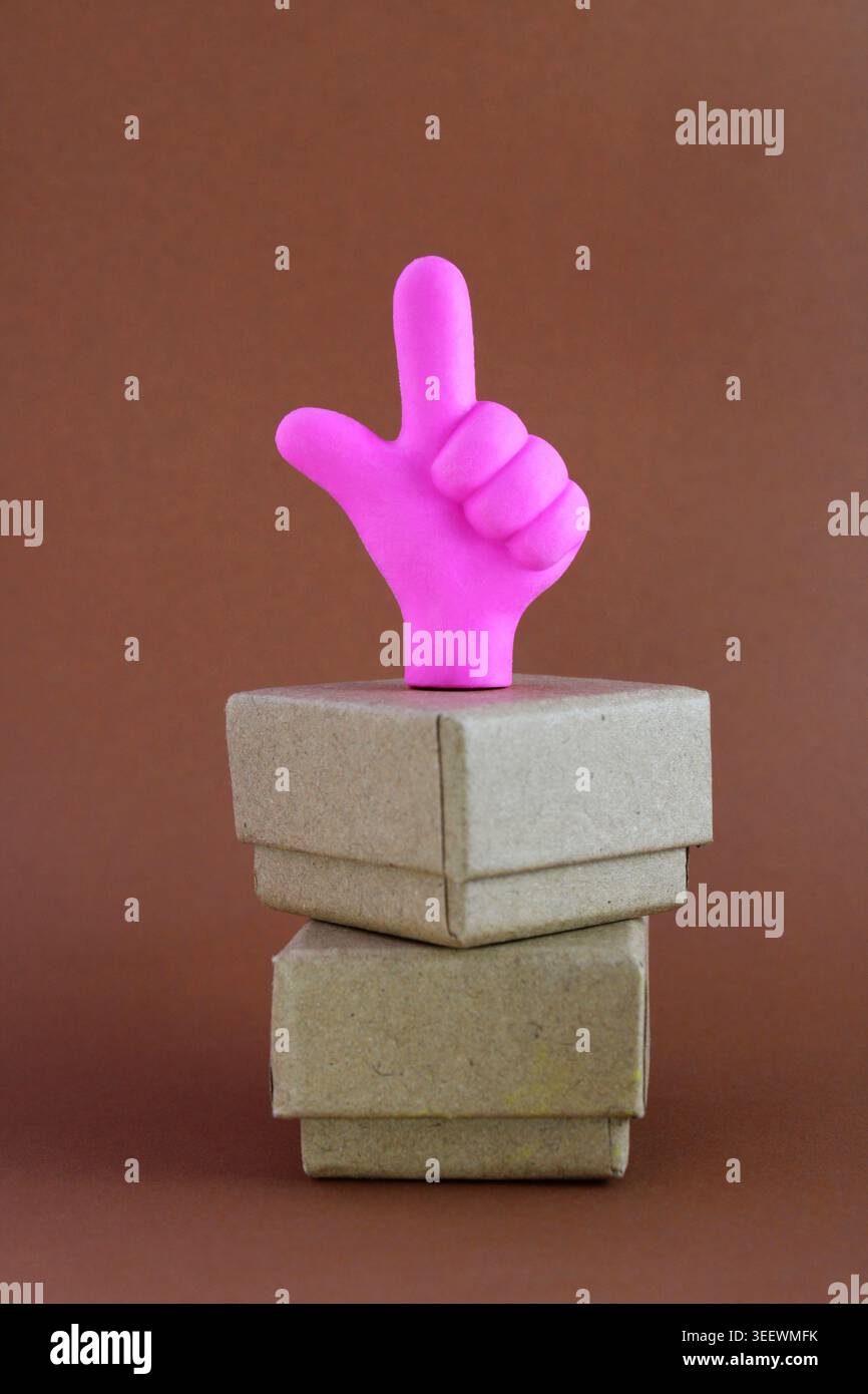 Hand raised, ready to deliver two boxes Stock Photo