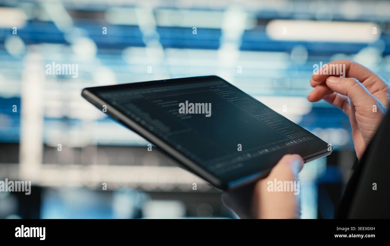Using coding application, tablet and programmer in data center optimizing equipment rigs. Adjusting system parameters, programming script close up and IT professional in server hub camera B Stock Photo