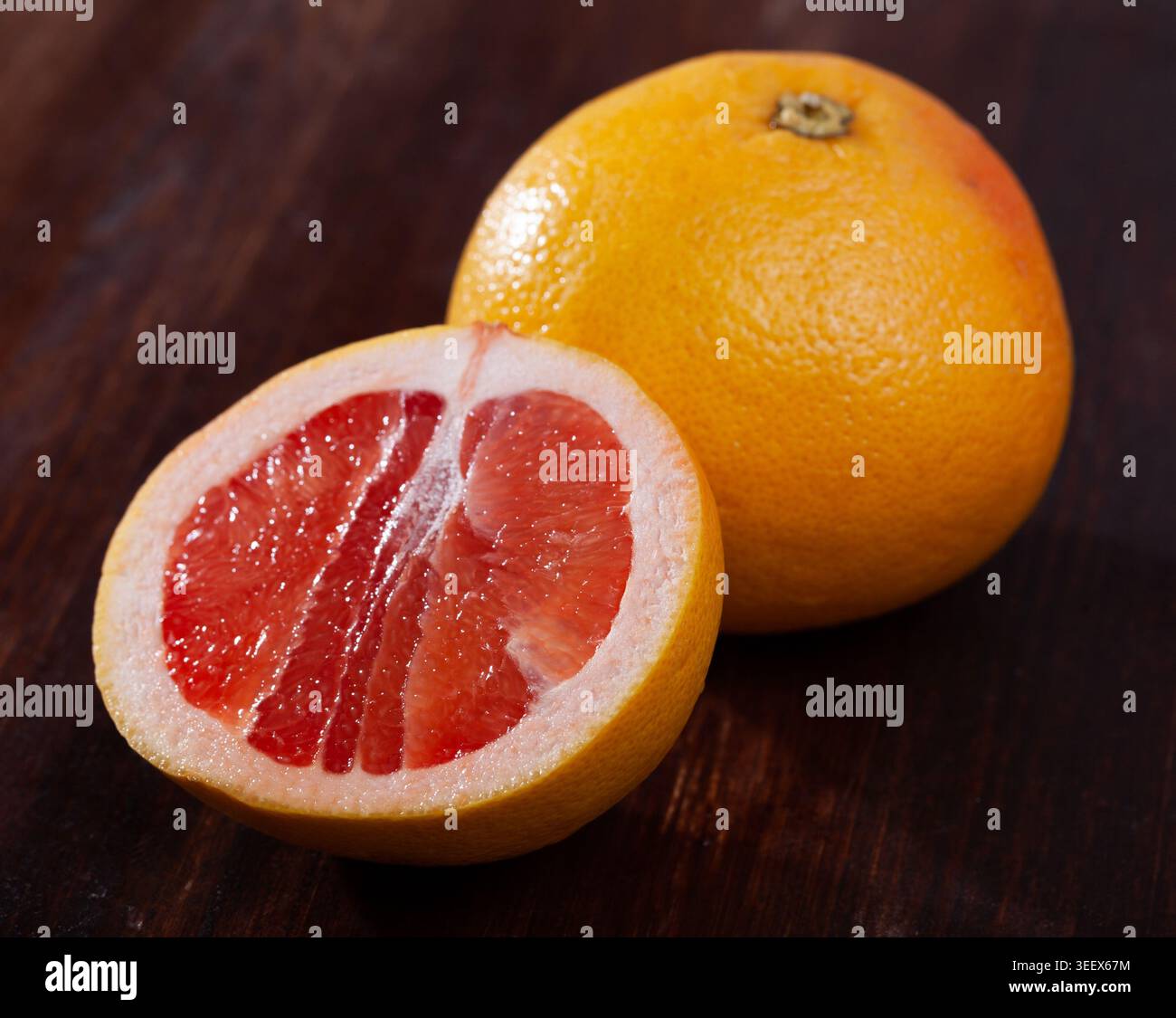 Sliced grapefruit on wooden table Stock Photo