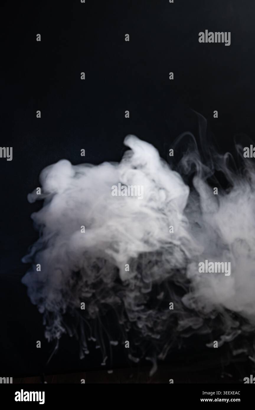 Dense white smoke cloud isolated on black background Stock Photo