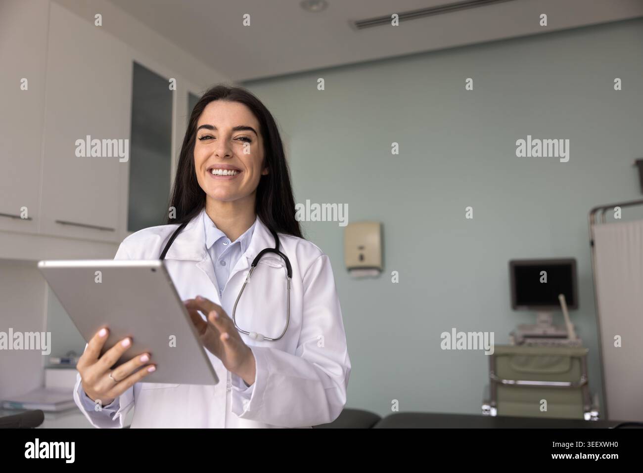 Latina healthcare professional woman posing for camera with tablet Stock Photo