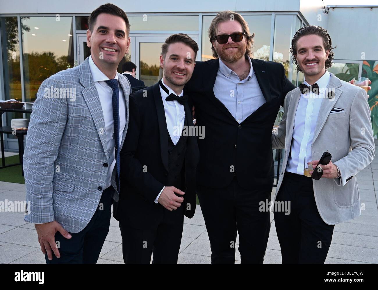 Four handsome men in formal suit having fun Stock Photo