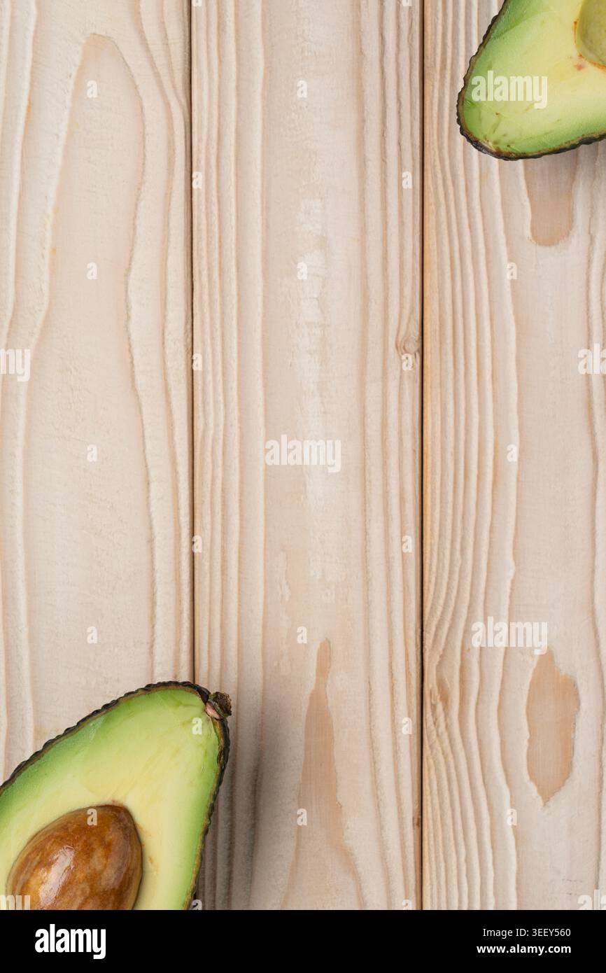 Avocado background with copy space on light wooden texture Stock Photo