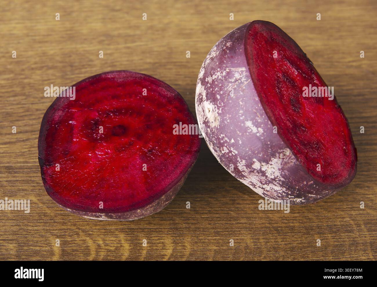 One beetroot divided into two. Over wooden background Stock Photo