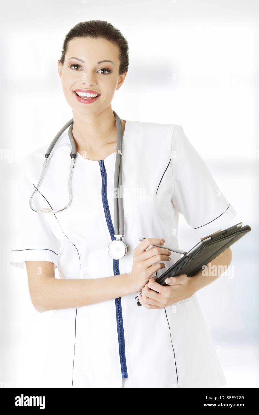 Female doctor using tablet computer, isolated on white Stock Photo