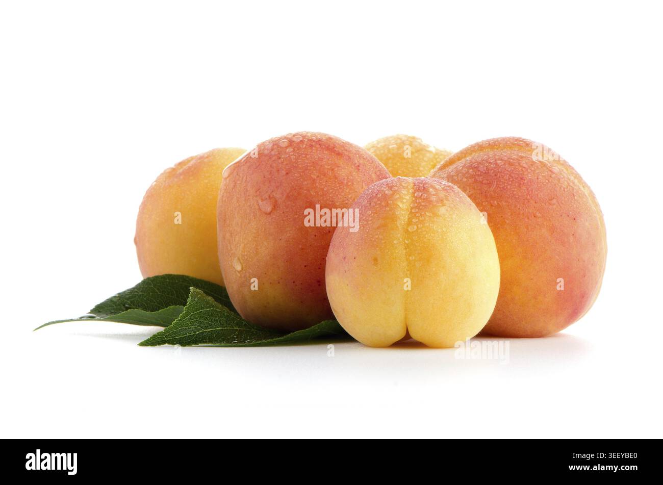 Sweet peaches with leafs on a white background Stock Photo