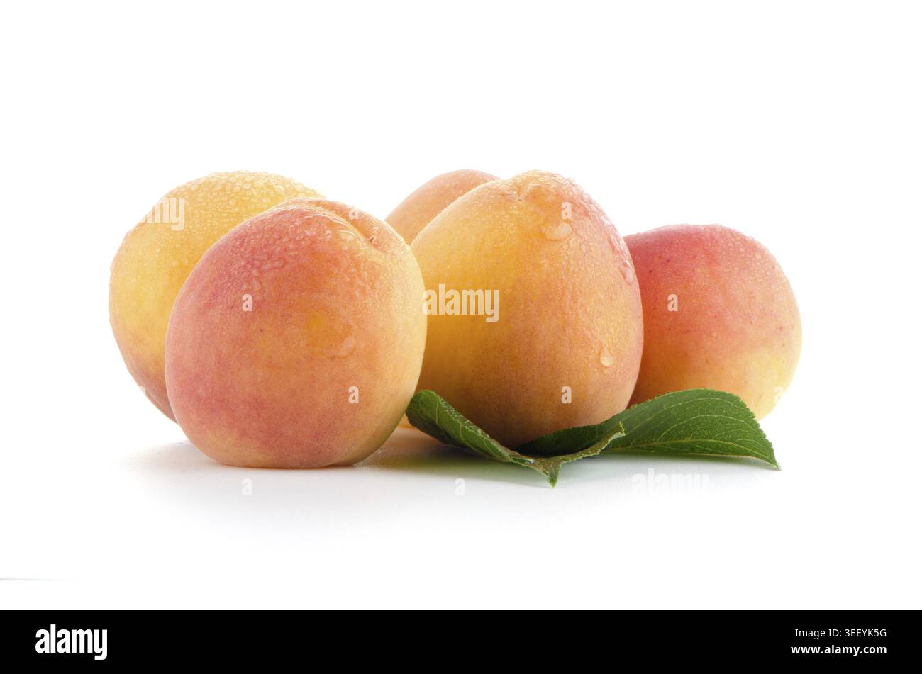 Sweet peaches with leafs on a white background Stock Photo