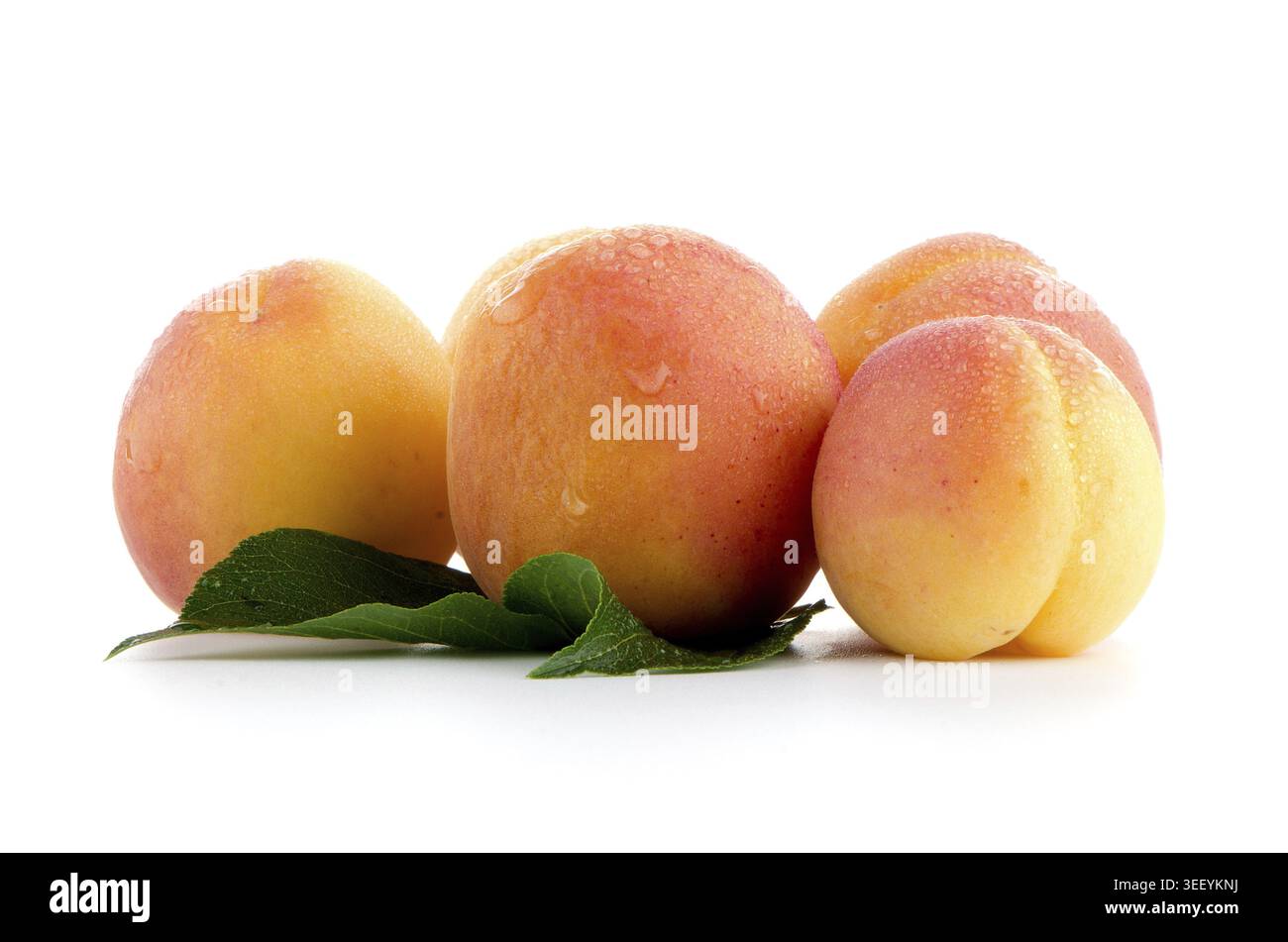 Sweet peaches with leafs on a white background Stock Photo