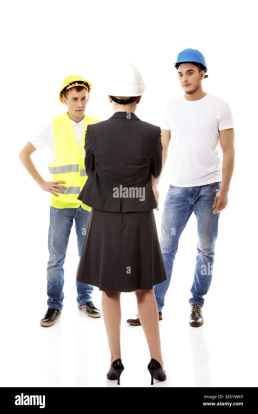Female engineer talking with two builders Stock Photo