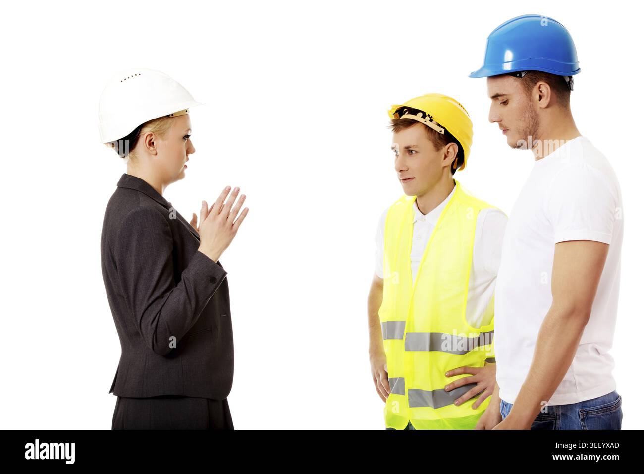 Female engineer talking with two builders Stock Photo
