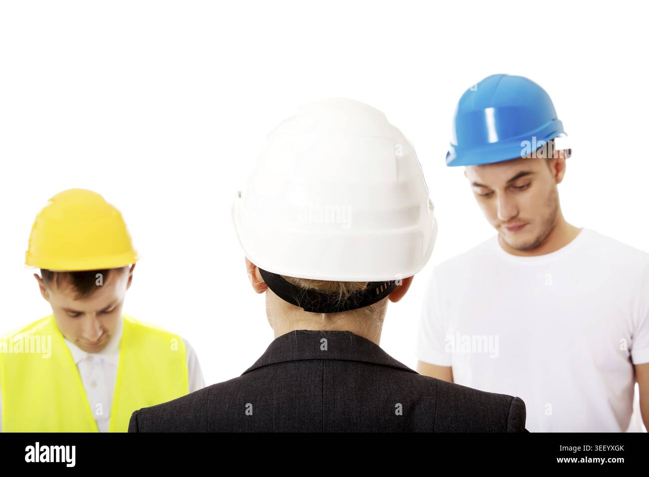 Female engineer talking with two builders Stock Photo